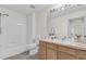 Well-lit bathroom featuring a tub with shower, wooden vanity, and neutral tiling at 3960 Southpointe Dr # 509, Orlando, FL 32822