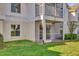 This ground floor patio features screen and lush grass, and a view of the building at 3960 Southpointe Dr # 509, Orlando, FL 32822