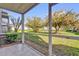 The screened in patio features a tile floor and a view of lush green grass and mature trees at 3960 Southpointe Dr # 509, Orlando, FL 32822