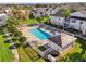 Aerial shot of the community pool surrounded by green grass and white fencing at 3960 Southpointe Dr # 509, Orlando, FL 32822