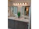 Elegant bathroom featuring double sinks, granite counters, and decorative mirrors at 419 Aldama Ave, Lady Lake, FL 32159