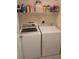 Practical laundry area with washer, dryer, and shelving for storage at 419 Aldama Ave, Lady Lake, FL 32159