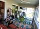 Bright sunroom with green chairs, sliding glass doors, and colorful rug at 419 Aldama Ave, Lady Lake, FL 32159