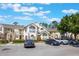 Condominium building's facade showcases a parking lot, brick archways, and second story balconies at 5007 Laguna Bay Cir # 31, Kissimmee, FL 34746