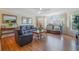 Cozy living room featuring three leather sofas, hardwood floors, and large window at 5007 Laguna Bay Cir # 31, Kissimmee, FL 34746