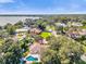 An aerial view of a property with a backyard pool in a neighborhood near a lake on a sunny day at 5205 Saint Regis Pl, Belle Isle, FL 32812