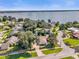 Stunning aerial view of the neighborhood highlighting the lake and the lush landscaping of the properties at 5205 Saint Regis Pl, Belle Isle, FL 32812