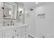 Bright bathroom with white tile, bronze fixtures, and a clear glass shower door at 5205 Saint Regis Pl, Belle Isle, FL 32812