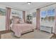 Inviting bedroom with pink accents, natural light, and hardwood floors at 5205 Saint Regis Pl, Belle Isle, FL 32812