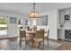 Bright dining room with a wooden table, elegant lighting, and views of the backyard pool at 5205 Saint Regis Pl, Belle Isle, FL 32812