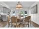 Well-lit dining room featuring hardwood floors, modern lighting, and easy access to the kitchen at 5205 Saint Regis Pl, Belle Isle, FL 32812