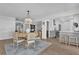 Bright dining area with modern chandelier, wood floors and open concept design to kitchen and living room at 5205 Saint Regis Pl, Belle Isle, FL 32812