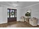 Inviting foyer with decorative wallpaper, wooden floors, and sophisticated furnishings at 5205 Saint Regis Pl, Belle Isle, FL 32812