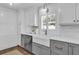 Bright and updated kitchen featuring white cabinets, gray island, stainless appliances, and modern fixtures at 5205 Saint Regis Pl, Belle Isle, FL 32812