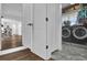 This laundry room has matching appliances, white shaker cabinets, with a peek into the rest of the house at 5205 Saint Regis Pl, Belle Isle, FL 32812