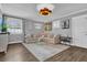 Inviting living room featuring a comfortable sofa, neon sign, curated artwork, a keyboard, and ample natural light at 5205 Saint Regis Pl, Belle Isle, FL 32812