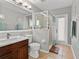 Modern bathroom with glass shower, dark wood vanity, and double mirror at 548 Hebrides Ct, Apopka, FL 32712