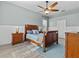 Inviting bedroom with a wood-framed bed, wood flooring, ceiling fan, and natural light at 548 Hebrides Ct, Apopka, FL 32712