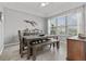 Dining room with a wood table, bench seating, and large windows at 548 Hebrides Ct, Apopka, FL 32712