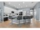 Kitchen island featuring bar stool seating, white countertop, cabinets, and modern faucet at 548 Hebrides Ct, Apopka, FL 32712