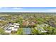 Aerial view highlighting the community's tennis courts, pool, and manicured landscaping at 6007 Scotchwood Gln # 37, Orlando, FL 32822