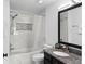 Clean and bright bathroom featuring a shower-tub combo and granite sink at 6007 Scotchwood Gln # 37, Orlando, FL 32822