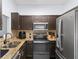 Well-equipped kitchen featuring stainless steel appliances and granite countertops at 6007 Scotchwood Gln # 37, Orlando, FL 32822