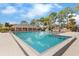 Community pool with lounge chairs and a covered pavilion at 6007 Scotchwood Gln # 37, Orlando, FL 32822