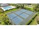 Aerial view of the community tennis courts next to the pool at 6007 Scotchwood Gln # 37, Orlando, FL 32822