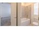 Bathroom features a combined shower and tub with tiled walls and modern toilet at 6140 Shavasana Rd, Clermont, FL 34714