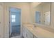 Bright bathroom showcasing a large vanity, modern faucet, and doorway to the bedroom at 6140 Shavasana Rd, Clermont, FL 34714