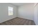 Carpeted bedroom with a window offering natural light and ample closet space at 6230 Shavasana Rd, Clermont, FL 34714