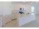 Well-lit kitchen featuring white cabinetry, stainless steel appliances, and a center island at 6230 Shavasana Rd, Clermont, FL 34714