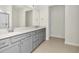 Bright bathroom featuring double vanity with gray cabinetry, quartz countertop and tiled floors at 6383 Trailblaze Bnd, St Cloud, FL 34771