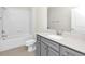 Bathroom with white shower and tub, gray vanity, and a large mirror at 6383 Trailblaze Bnd, St Cloud, FL 34771