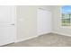 Bedroom with gray carpet, white walls, closet with sliding doors, and a window at 6383 Trailblaze Bnd, St Cloud, FL 34771