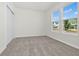 Bedroom with gray carpet, white walls, closet, and two windows bringing in natural light at 6383 Trailblaze Bnd, St Cloud, FL 34771