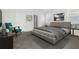 Bedroom featuring gray carpet, white walls, accent chair, and a bed with decorative pillows at 6383 Trailblaze Bnd, St Cloud, FL 34771