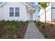 Inviting front entrance with a charming walkway leading to a stylish, light-blue front door at 6383 Trailblaze Bnd, St Cloud, FL 34771