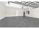 Spacious garage with epoxy floor, door to interior, and garage door opener at 6383 Trailblaze Bnd, St Cloud, FL 34771