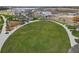 Aerial view of community park with large green lawn, playground and sidewalk paths at 6383 Trailblaze Bnd, St Cloud, FL 34771