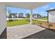 View from covered brick paver patio to street with manicured lawns and sidewalks at 6383 Trailblaze Bnd, St Cloud, FL 34771