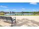 A serene view from a bench overlooking a community pond with homes visible in the distance at 6383 Trailblaze Bnd, St Cloud, FL 34771