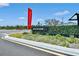 Weslyn Park neighborhood sign with landscaping and community flag on a sunny day at 6383 Trailblaze Bnd, St Cloud, FL 34771