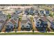 A street view of houses with well-maintained lawns, showcasing the neighborhood's curb appeal and landscape at 6383 Trailblaze Bnd, St Cloud, FL 34771