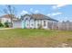 Landscaped single-story home with gray exterior, fenced yard, and a blue front door at 647 Holbrook Ave, Deltona, FL 32738