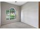 Light-filled bedroom showcasing a large arched window that overlooks the front yard at 763 Via Milano, Apopka, FL 32712