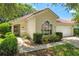 Well-maintained home with a terracotta roof, two-car garage, and lush green landscaping at 763 Via Milano, Apopka, FL 32712