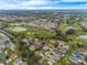 Beautiful aerial view of a community with mature trees, a lake, and golf course at 7978 Se 174Th Belhaven Loop, The Villages, FL 32162