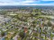 Aerial view of a residential neighborhood with a golf course, trees, and a blue sky at 7978 Se 174Th Belhaven Loop, The Villages, FL 32162